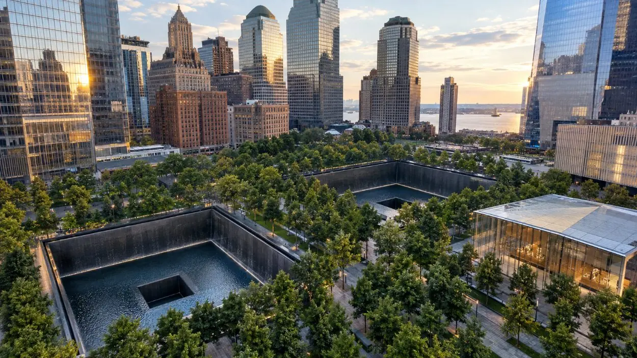 A wide view over the memorial plaza with both pools, the oaks and the museum pavilion