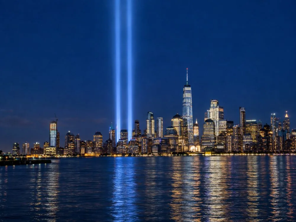 Two beams of light rising over Lower Manhattan at night